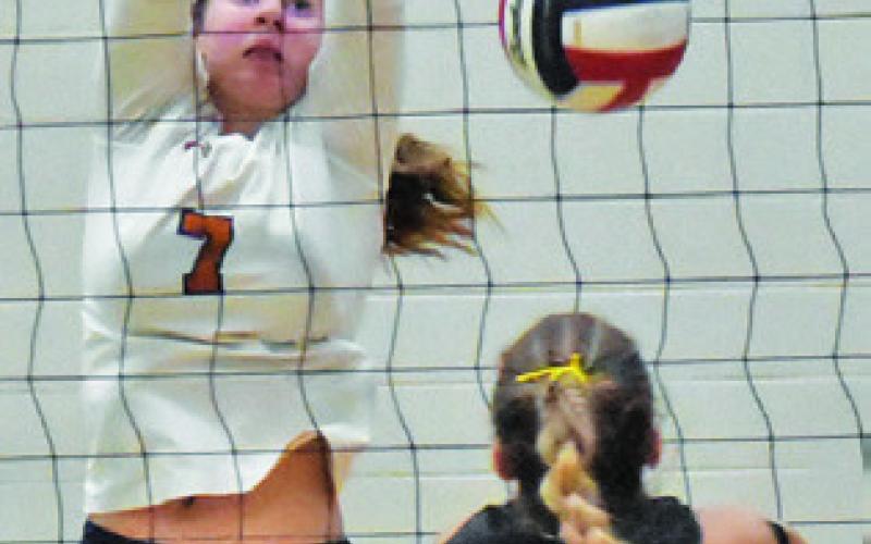 LYDIA GIESE stretches to attempt a block from a Baylee Brandes hit during the Caldwell-Sealy bi-district match last Thursday. Tribune photo by Roy Sanders