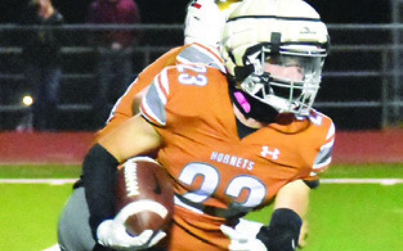 BRAXTON FRITCHER carries the ball for Caldwell last Friday against Sealy. Tribune photo by Roy Sanders