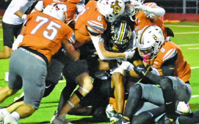 THE CALDWELL HORNETS make a tackle last Friday including R.J. Gonzales, Kyson Strange, Dylan Carter and Krush Strange. Tribune photo by Roy Sanders