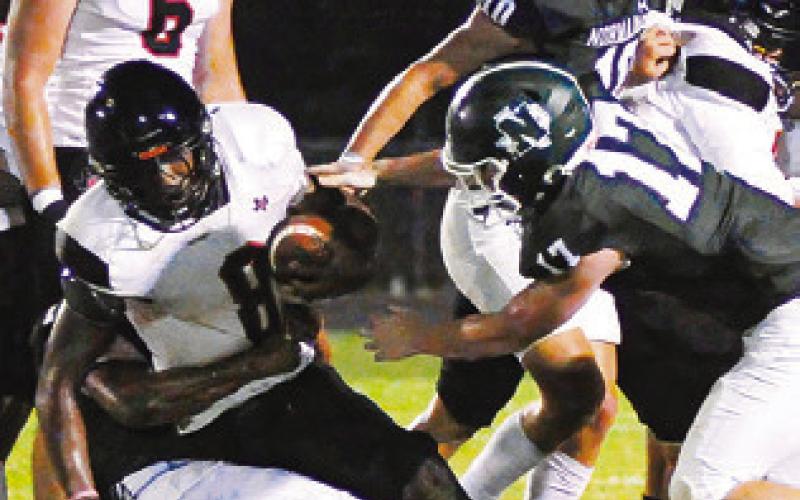JA’KEITH Daniels carries the ball for Somerville. Also pictured is teammate Irman Sadic. Tribune photo by Denise Squier