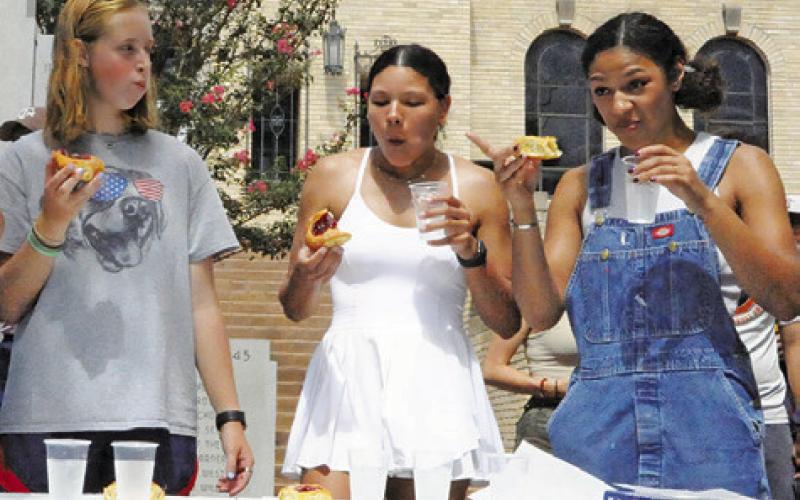 THEY ARE EATING as fast as possible at the annual kolache eating contest. Tribune photo by Denise Squier