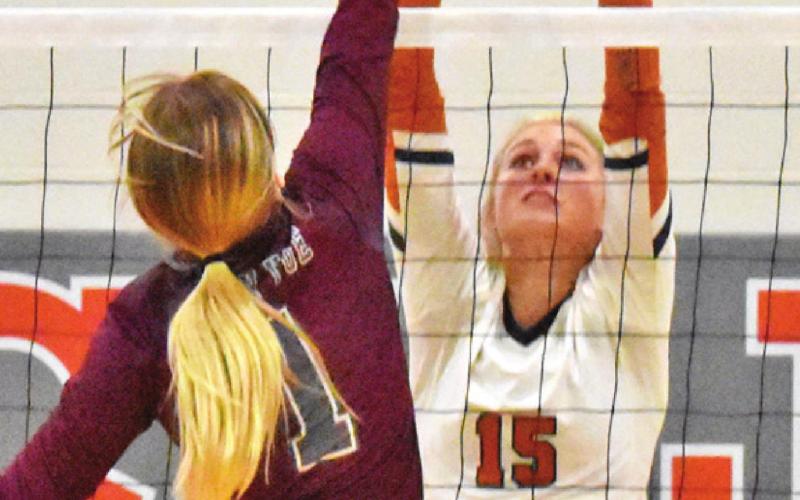 LEXIE ALBRIGHT reaches to try to block a hit from Sydni Smith during the Caldwell-Cameron Yoe match last Friday afternoon.