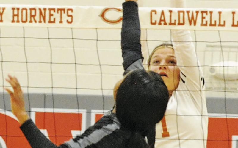 ASHLYN KELLUM reaches to attempt a block during the Caldwell-Manor New Tech match last Friday afternoon in Hornet Gym.