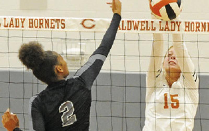 Lexie Albright gets one of her three blocks against Manor New Tech last Friday with this blocked hit from New Tech’s Naqell Best.