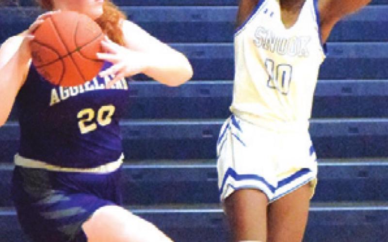 BRE’ASIA LOUIS tries to interfere with the pass from an Aggieland HomeSchool player during Snook’s 40-25 loss to the Lady Panthers.