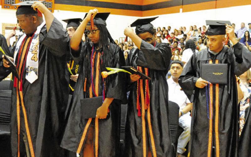 SOMERVILLE HIGH SCHOOL graduates move their tassels at the conclusion of Saturday morning’s graduation ceremony.