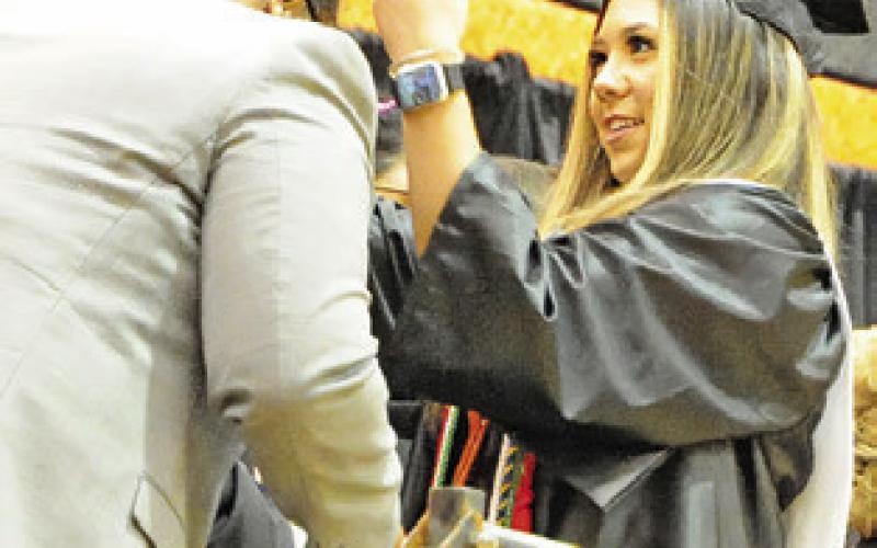 SOMERVILLE GRADUATE Bryanna Surovik places a string of beads on high school principal Steven Toliver. Every graduate gave Toliver a set of beads as a gesture to remember them. -- Tribune photo by Denise Squier