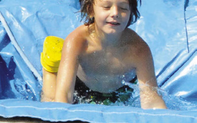 WATER SLIDES were part of the fun at last Thursday’s Special Event Thursday, hosted by the Harrie P. Woodson Memorial Library. Tribune photo by Denise Squier