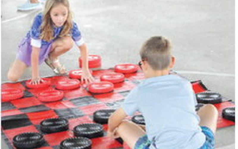 GIANT BOARD GAMES also were part of last Thursday’s Special Event Thursday, hosted by the Harrie P. Woodson Memorial Library. Tribune photo by Denise Squier