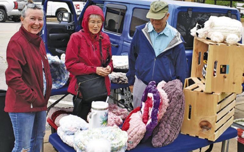 JULIE GEESLIN OF Rebel’s Yarn N Paws displays these items on Saturday, March 28, at the Farmers Market in downtown Caldwell.