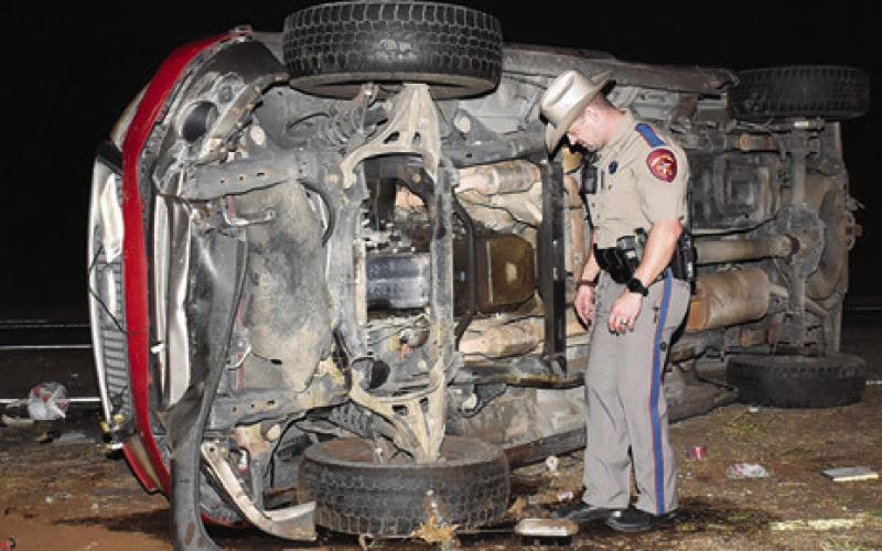 A DPS TROOPER works the scene of this accident on Thursday night, Nov. 20, on State Highway 21 West near the F.M. 60 intersection.