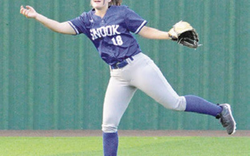 PATRICIA MORSE barehands the ball to throw it back into the infield during the Snook-Bremond area game last Thursday at Navasota High School.
