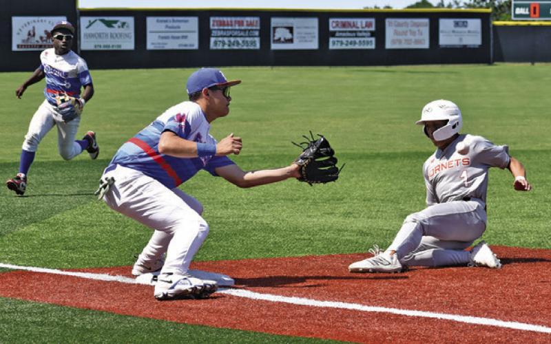 KORBIN BURNS SLIDES safe into third base in the Brookshire Royal game. Tribune photo by Roy Sanders