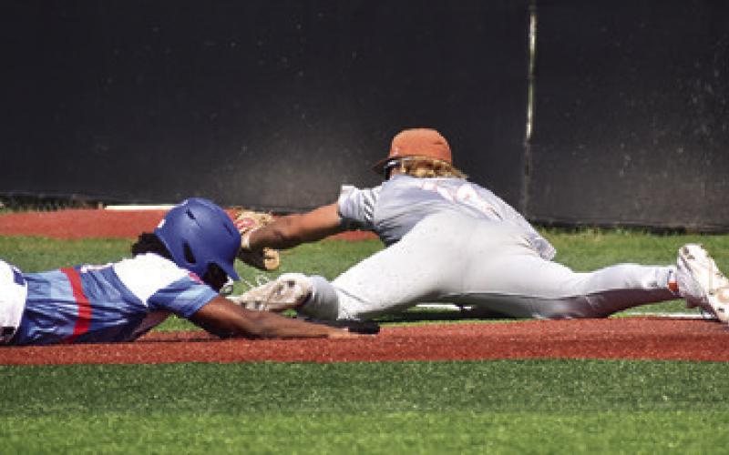 P.J. SUPAK OF CALDWELL reaches for the ball at first base in the Brookshire Royal game. Tribune photo by Roy Sanders