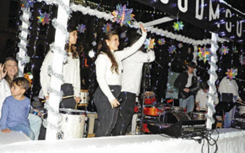LOUDMOUTH MUSIC ACADEMY rocked downtown Caldwell during the lighted Christmas parade with its rendition of “The Little Drummer Boy” -- featuring live musicians and vocalists in its float. Tribune photo by Denise Squier