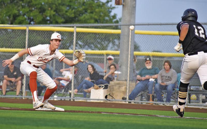 CALDWELL’S RYAN SEE LOOKS CAREFULLY at the approaching ball as this Giddings base runner heads for second base. -- Tribune photo by Roy Sanders