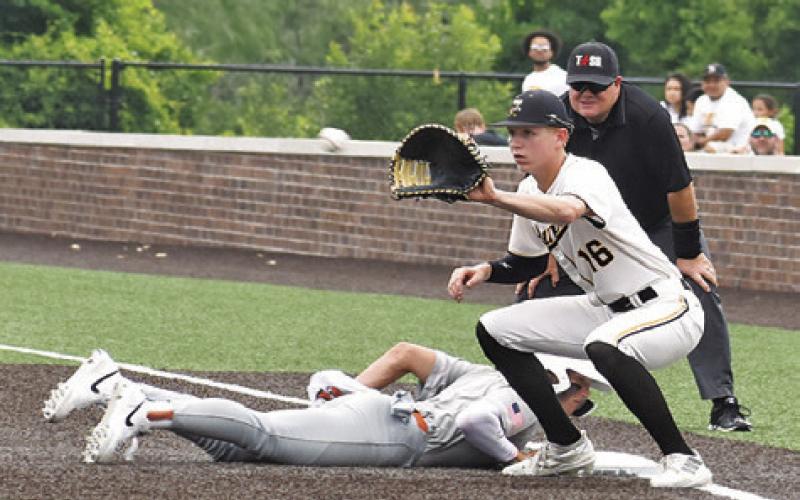 CALDWELL’S COY BECKA slides back into first base in time to be safe in the Thursday game. -- Tribune photo by Roy Sanders