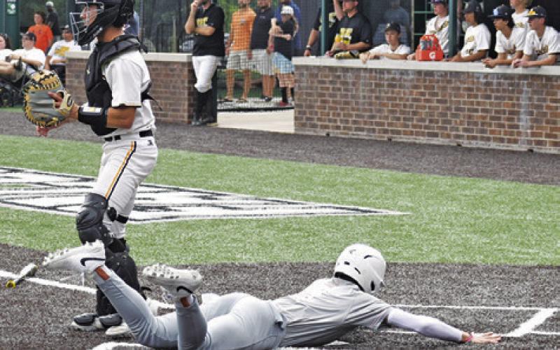 COY BECKA OF Caldwell slides into home plate safe for a run against Gatesville on May 9 in Waco. -- Tribune photo by Roy Sanders