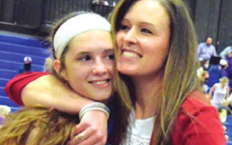 SNOOK HEAD BASKETBALL Coach Micah Goebel hugs Riley Green after the Lady Jays won their Class 2A regional final game. Snook girls reaching the state semifinals was the county’s Number 3 sports story for 2021.