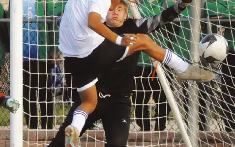LEFT: CALDWELL’S RAMON LEYVA heads the ball down the field during the Hornets’ game against Florence in the Yoe Invitational Soccer Tournament last Thursday. RIGHT: CALDWELL GOALIE R.J. King defends against an attempt to score a goal by a Florence striker during the Yoe Invitational Soccer Tournament last week. -- Tribune photos by Denise Squier