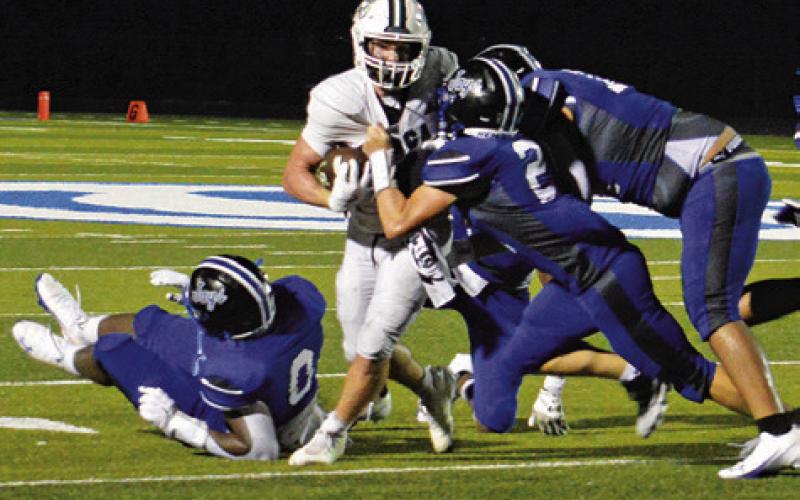 THE SNOOK DEFENSE makes a tackle last Friday against NBCA in the season opener in Snook. Tribune photo by Kim Hutcheson