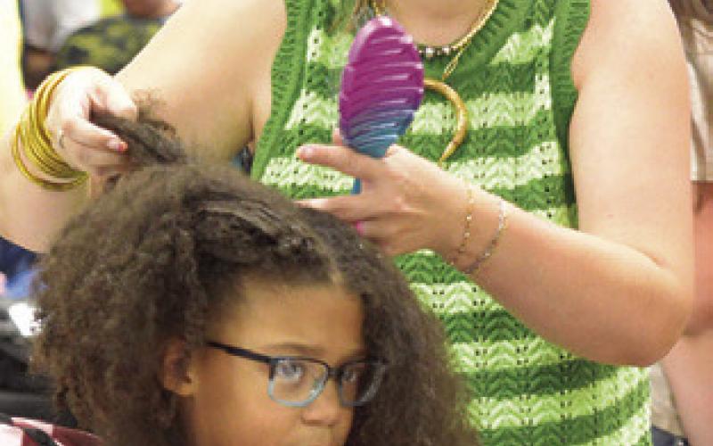 THE BACK TO SCHOOL Blast event not only gave out school supplies to area students, they were able to get free hair cuts and hair styles. Tribune photo by Denise Squier