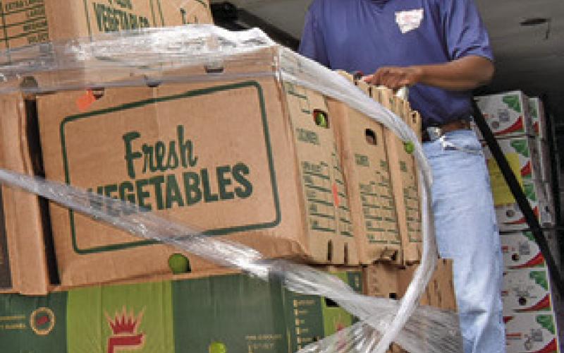 MARQUIS PRATT OF the Brazos Valley Food Bank delivers food on Saturday morning, July 12, to the food pantry at In God’s Hands Ministry at Cade Lake. The ministry helps local residents.