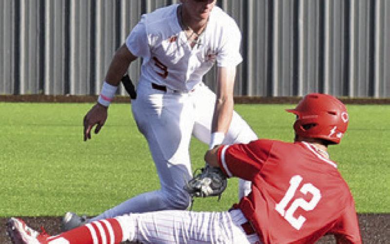 RYAN SEE of Caldwell tags this Salado base runner in the round two playoff game. Tribune photo by Roy Sanders