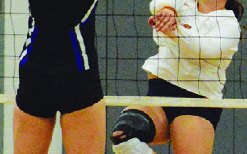 KIERSTYN MACIK earns a “K” in the kill column, getting the ball past an Anderson-Shiro blocker on Friday.