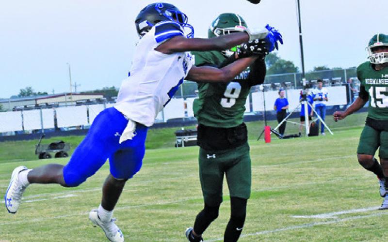SNOOK’S JOHN CARR and a Normangee defender go for the ball in last Friday night’s game in Normagnee. Tribune photo by Roy Sanders