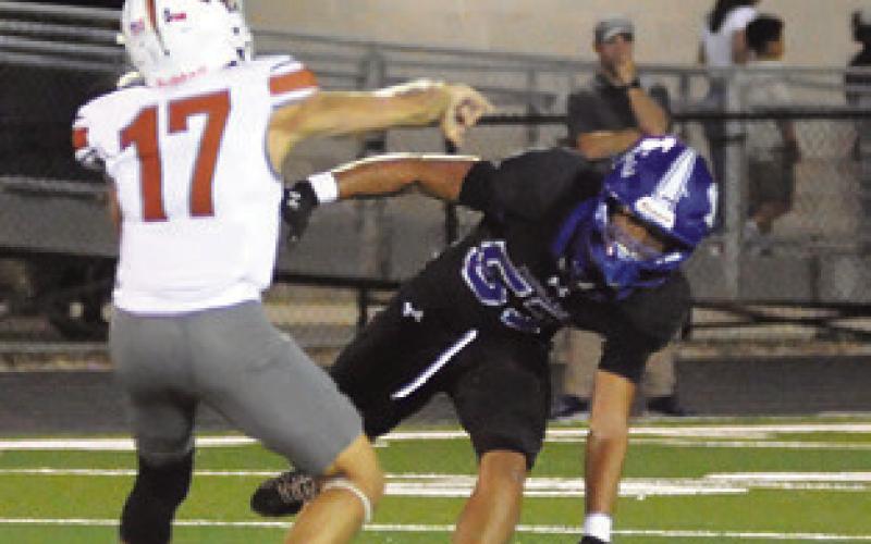 KORBIN BURNS of Caldwell throws this pass against the Jarrell defense. Tribune photo by Denise Squier