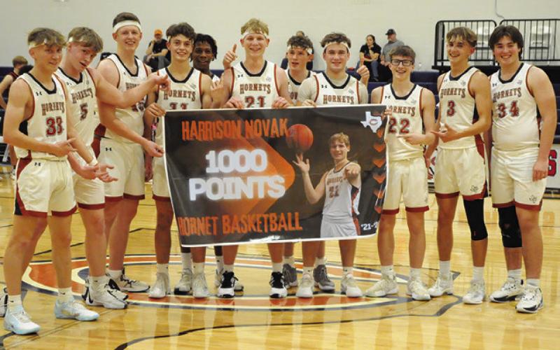 HARRISON NOVAK AND teammates celebrate his 1,000th point as a high school player.