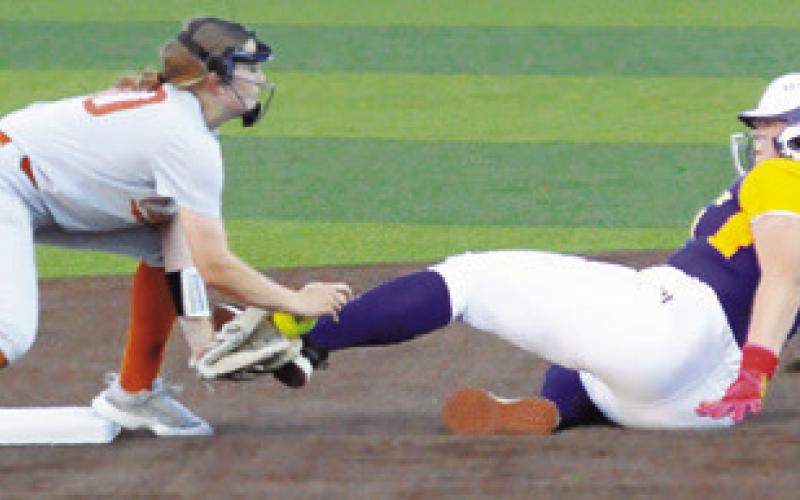 A LA GRANGE PLAYER slides into the glove of Caldwell’s Kelly Urbanovsky at second base, knocking the ball out of the glove, during the Caldwell-La Grange game on Friday. -- Tribune photo by Denise Squier