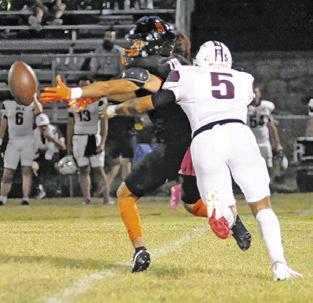 KYLE BROOKS of Somerville reaches for the ball as this Iola defender moves in. Tribune photo by Denise Squier