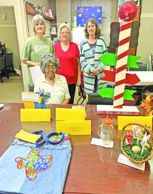 BURLESON COUNTY EEA Cultural Arts Competition Chair Audrey Swain (seated) and her committee members Karen Gaas, Tammy Qualls-Tucker and Debbie Abbott are pictured with some of the entries submitted by EEA Club members for their Burleson EEA Cultural Arts Competition held Feb. 21.