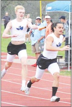 A SNOOK RELAY TEAM passes tbe baton cleanly during last week’s Koppers Relays.