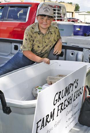 MASON McCULLOCH helps with Grumpy’s Farm Fresh Eggs at the Farmers Market on Saturday, May 16, in downtown Caldwell.