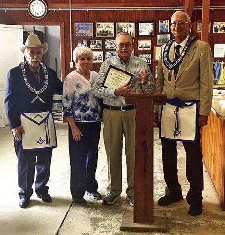 CARLCUMMINSRECEIVED THE prestigious Community Builder award at the Lee Scott Masonic Lodge’s March 15 gathering. Pictured, from left, Jack Womack, WM, Ruth Cummins, Carl Cummins and Jim Braml, PM.