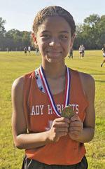 AJRIANA SIMS won the girls race at the district junior high cross country meet last Tuesday.