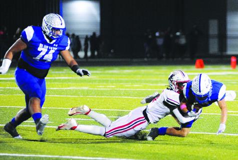 LANCE LARA CARRIES the ball for Snook against Burton. Also pictured is Snook’s Gabe Martinez. See story inside. -- Tribune photo by Denise Squier