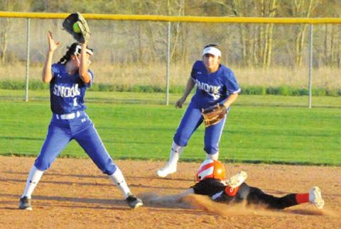 SOMERVILLE’S CAYLA BALANGA slides safely into second base while Snook’s Paola Arredondo sets to attempt a tag. Also pictured is Snook’s Nadia Garcia. -- Tribune photo by Denise Squier