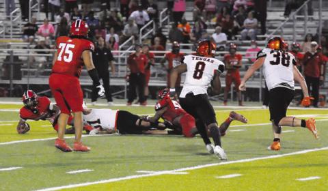 MARTIN ESPINOZA SACKS THE quarterback on the last play as Keke Daniels and Moses Stickel move in. Somerville won 42-41 in overtime to go 3-0 in district play. Tribune photo by Denise Squier
