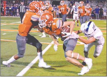 JAMIN WHITE OF Caldwell fights past this Robinson defender in the Hornets 28-0 home loss last Friday. -- Tribune photo by Roy Sanders
