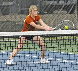 JORDAN PERKKIO volleys at the net during a mixed doubles match last Friday at the Caldwell Invitational Varsity Tournament.