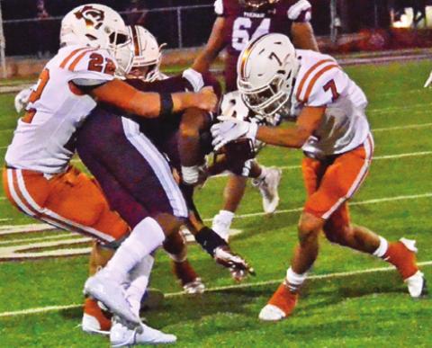 CALDWELL’S LARAMIE PIEPER and Zach Heaton make this tackle last Friday against Cameron. -- Tribune photo by Roy Sanders