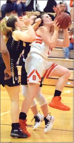 HALLE STEVENS is pounded by two North Zulch players while trying to shoot the ball, drawing the foul during the Lady Yegua’s win Friday. -- Tribune photo by Denise Hornaday