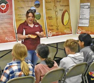 BURLESON COUNTY AGRILIFE Extension Agent Holly Narro addresses these fifth-graders on May 7 at the Burleson County Ag &amp; Health Safety Day held at the county expo center.