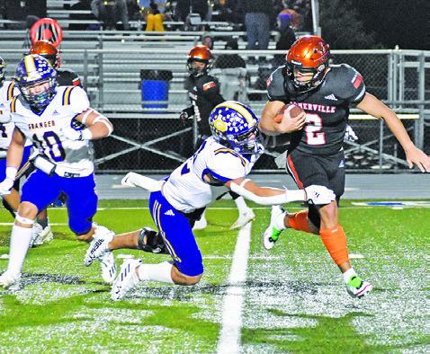 IAN TEAGUE OF Somerville carries the ball against Granger in the bi-district playoff game. -- Tribune photo by Roy Sanders