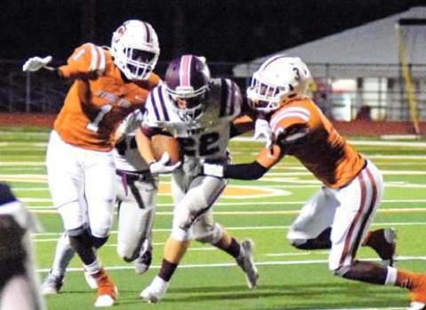 CALDWELL’S JAMAR HEWITT and Dontavien Johnson try to tackle Troy’s Brady Bearden during the Hornets’ home loss last Friday night.
