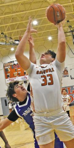 KOY MACIK of Caldwell leaps high for this shot last Friday against Navasota. Tribune photo by Roy Sanders